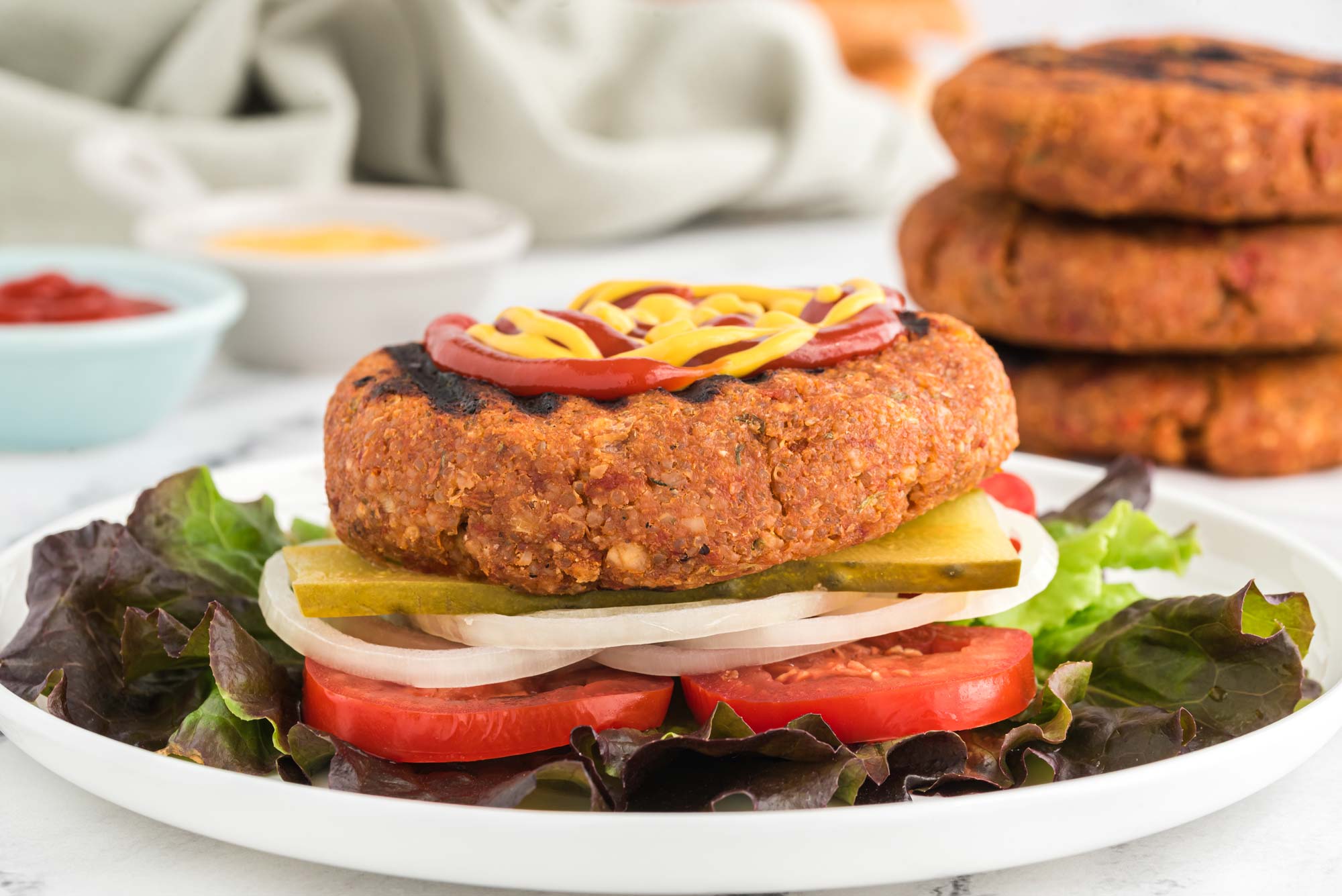 umami sun dried tomato and almond burger on plate