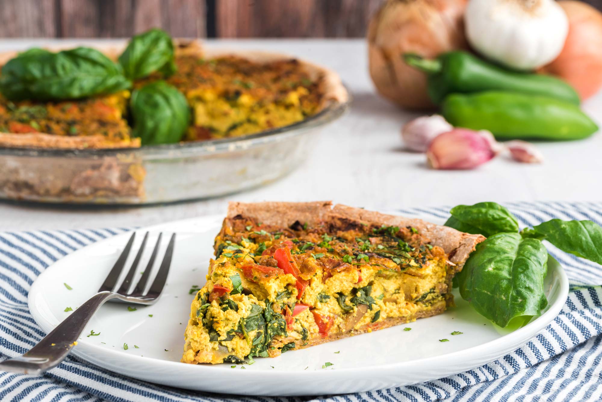 veggie quiche slice on plate - healthy pie recipes